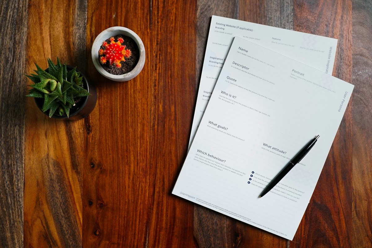 Papers and a pen on a wooden table