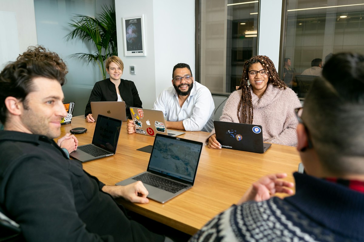 Colleagues discussing a project around a table