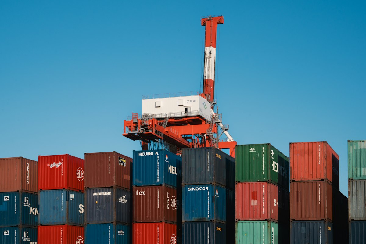 Shipping containers and gantry cranes at a port terminal